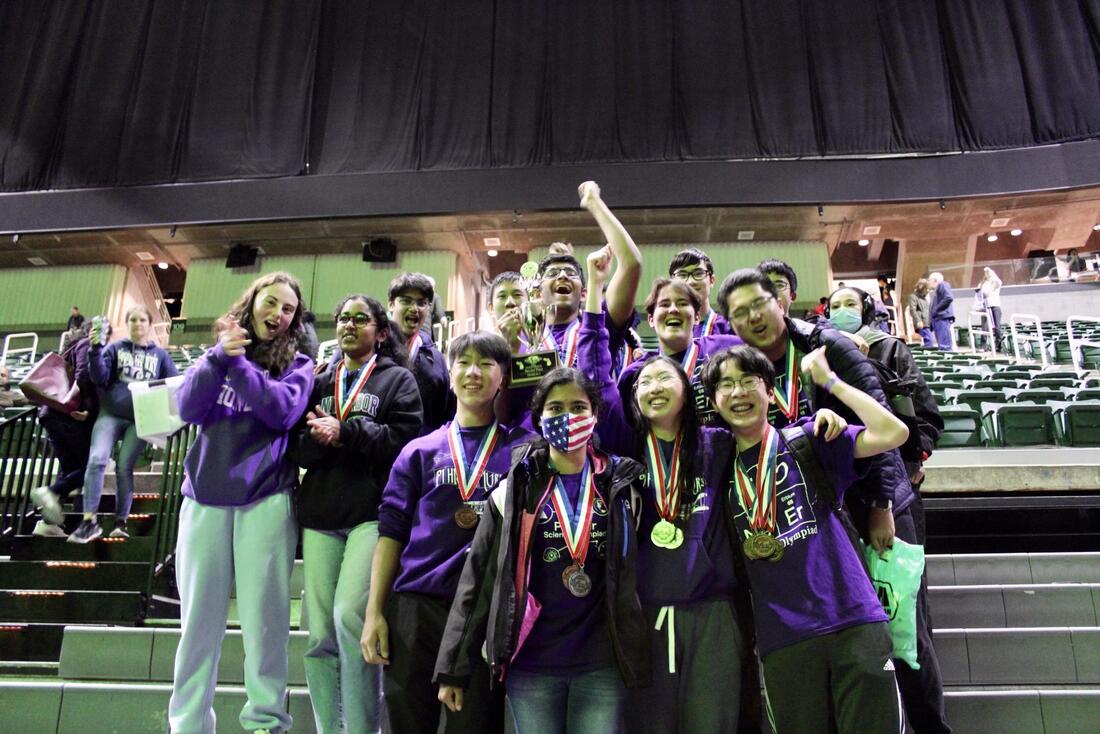 Pioneer Science Olympiad students holding awards at a tournament.